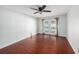 Bedroom with hardwood floors and French doors leading to the pool area at 16201 Country Crossing Dr, Tampa, FL 33624