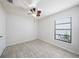 Light-filled bedroom with wood-look floors, ceiling fan, and a window at 16201 Country Crossing Dr, Tampa, FL 33624