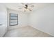 Bright bedroom with wood-look floors, a ceiling fan, and a window at 16201 Country Crossing Dr, Tampa, FL 33624