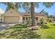 Charming single-story home with a manicured lawn, white picket fence, and a two-car garage at 16201 Country Crossing Dr, Tampa, FL 33624