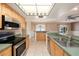 Bright kitchen with stainless steel appliances, tile flooring and skylight at 16201 Country Crossing Dr, Tampa, FL 33624