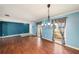 Spacious living room with elegant chandelier, hardwood floors, and natural light at 16201 Country Crossing Dr, Tampa, FL 33624