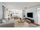 Staged living room featuring hardwood floors, neutral walls, and modern decor at 16201 Country Crossing Dr, Tampa, FL 33624