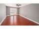 Spacious living room with ceiling fan and doors leading to the pool area at 16201 Country Crossing Dr, Tampa, FL 33624