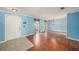 Cozy living room featuring wood floors, two windows and a view into other rooms at 16201 Country Crossing Dr, Tampa, FL 33624