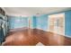 Bright living room with wood floors, blue walls, and natural light from large windows at 16201 Country Crossing Dr, Tampa, FL 33624