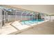 Inviting screened-in pool area with clear blue water, perfect for relaxation and outdoor enjoyment at 16201 Country Crossing Dr, Tampa, FL 33624