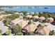 Beautiful aerial view of coastal homes featuring well-manicured lawns and stunning water views at 184 Banyan Bay Dr, St Petersburg, FL 33705