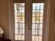 This image features a double door walkout to balcony and an exterior view of the community at 184 Banyan Bay Dr, St Petersburg, FL 33705