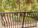 Balcony view showcasing lush greenery, architectural columns, and dark metal railing at 184 Banyan Bay Dr, St Petersburg, FL 33705
