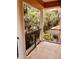 Balcony view showcasing lush greenery, architectural columns, and partial view of an outdoor gazebo at 184 Banyan Bay Dr, St Petersburg, FL 33705