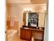 Bright bathroom featuring a soaking tub, tiled shower, and vanity with a large mirror at 184 Banyan Bay Dr, St Petersburg, FL 33705