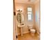 Powder room with pedestal sink, toilet, and natural light from a window at 184 Banyan Bay Dr, St Petersburg, FL 33705
