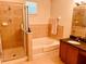 Bathroom featuring a stand-up shower, soaking tub, and granite countertops at 184 Banyan Bay Dr, St Petersburg, FL 33705