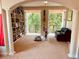 Bedroom with white columns and bookshelves, offering a peaceful view from the balcony at 184 Banyan Bay Dr, St Petersburg, FL 33705