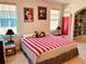 Comfortable bedroom featuring decor, a view of the neighborhood, and built-in bookcase at 184 Banyan Bay Dr, St Petersburg, FL 33705