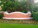 Banyan Bay entrance with manicured flowerbeds, lush trees, and attractive signage at 184 Banyan Bay Dr, St Petersburg, FL 33705