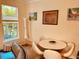 Bright dining area featuring a round table, contemporary chairs, and natural light from a nearby window at 184 Banyan Bay Dr, St Petersburg, FL 33705
