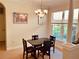 Elegant dining room with chandelier lighting and a view of the outdoors through large windows at 184 Banyan Bay Dr, St Petersburg, FL 33705