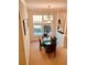 Formal dining room featuring a dark wood table, seating for four, and a view through large windows at 184 Banyan Bay Dr, St Petersburg, FL 33705