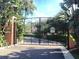 Image displays a gated entry, bordered with lush greenery and palm trees, providing privacy at 184 Banyan Bay Dr, St Petersburg, FL 33705