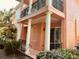 Exterior elevation of the home featuring a balcony, columns, and outdoor patio at 184 Banyan Bay Dr, St Petersburg, FL 33705
