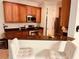 Kitchen features wooden cabinets, stainless steel appliances, granite countertops, and barstool seating at 184 Banyan Bay Dr, St Petersburg, FL 33705