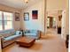 Inviting living room featuring striped sofas, neutral carpet, and bright natural light from the large window at 184 Banyan Bay Dr, St Petersburg, FL 33705