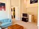Upstairs bonus room with a striped sofa, television, and view of the staircase at 184 Banyan Bay Dr, St Petersburg, FL 33705
