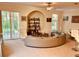Inviting living room featuring a unique rounded sofa, a decorative bookshelf, and lots of natural light at 184 Banyan Bay Dr, St Petersburg, FL 33705