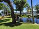 Scenic view showing tranquil pond with waterfall, green space, palm trees, and lake views at 184 Banyan Bay Dr, St Petersburg, FL 33705