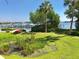 Waterfront scene showing dock and boats through lush landscaping and palm trees on a sunny day at 184 Banyan Bay Dr, St Petersburg, FL 33705