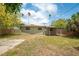 Backyard features a covered patio, storage shed, and mature landscaping at 1858 Oregon Ave Ne, St Petersburg, FL 33703