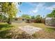 Wide shot of backyard featuring storage shed and covered patio at 1858 Oregon Ave Ne, St Petersburg, FL 33703