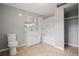 Bathroom with a shower-tub combo, vanity, and toilet with neutral tones at 1858 Oregon Ave Ne, St Petersburg, FL 33703