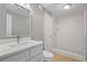 Bright bathroom featuring a marble-walled shower and updated vanity at 1858 Oregon Ave Ne, St Petersburg, FL 33703