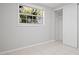 Bedroom featuring tile floors, closet with door, and window with view at 1858 Oregon Ave Ne, St Petersburg, FL 33703