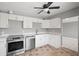 Modern kitchen with white cabinetry, stainless steel appliances, and tile flooring at 1858 Oregon Ave Ne, St Petersburg, FL 33703