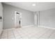 Open-concept living area featuring tile flooring, neutral colors, and an easy transition to other rooms at 1858 Oregon Ave Ne, St Petersburg, FL 33703