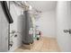 Utility room featuring water heater, tile floor, and drywall walls at 1858 Oregon Ave Ne, St Petersburg, FL 33703