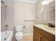 A well lit bathroom with a tub and shower combo, toilet, and a sink with a wooden vanity at 1864 Clearbrooke Dr, Clearwater, FL 33760