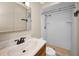 A clean bathroom features a toilet, a walk-in shower, and a single sink vanity with a framed mirror at 1864 Clearbrooke Dr, Clearwater, FL 33760