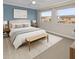 Serene bedroom featuring a bed, accent wall, two windows for natural light, and neutral carpeting at 1864 Clearbrooke Dr, Clearwater, FL 33760