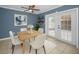 Bright dining room with white chairs, a table set for four, and doors leading to the backyard at 1864 Clearbrooke Dr, Clearwater, FL 33760