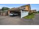 Carport view showing a car parked, white fence, and the home's exterior at 1864 Clearbrooke Dr, Clearwater, FL 33760