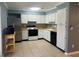 Well-lit kitchen with white cabinets, tile backsplash, modern appliances, and tile floors at 1864 Clearbrooke Dr, Clearwater, FL 33760