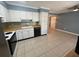 Functional kitchen with white cabinets, tile backsplash, modern appliances, and a tile floor at 1864 Clearbrooke Dr, Clearwater, FL 33760