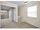 Upstairs landing features neutral carpet, a window, and doors to various rooms in the home at 1864 Clearbrooke Dr, Clearwater, FL 33760