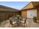 Cozy outdoor patio featuring a seating area, overhead lighting, and privacy fence at 1864 Clearbrooke Dr, Clearwater, FL 33760