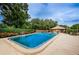 Inviting community pool with sun deck and shade trees, perfect for relaxing and entertaining at 1864 Clearbrooke Dr, Clearwater, FL 33760